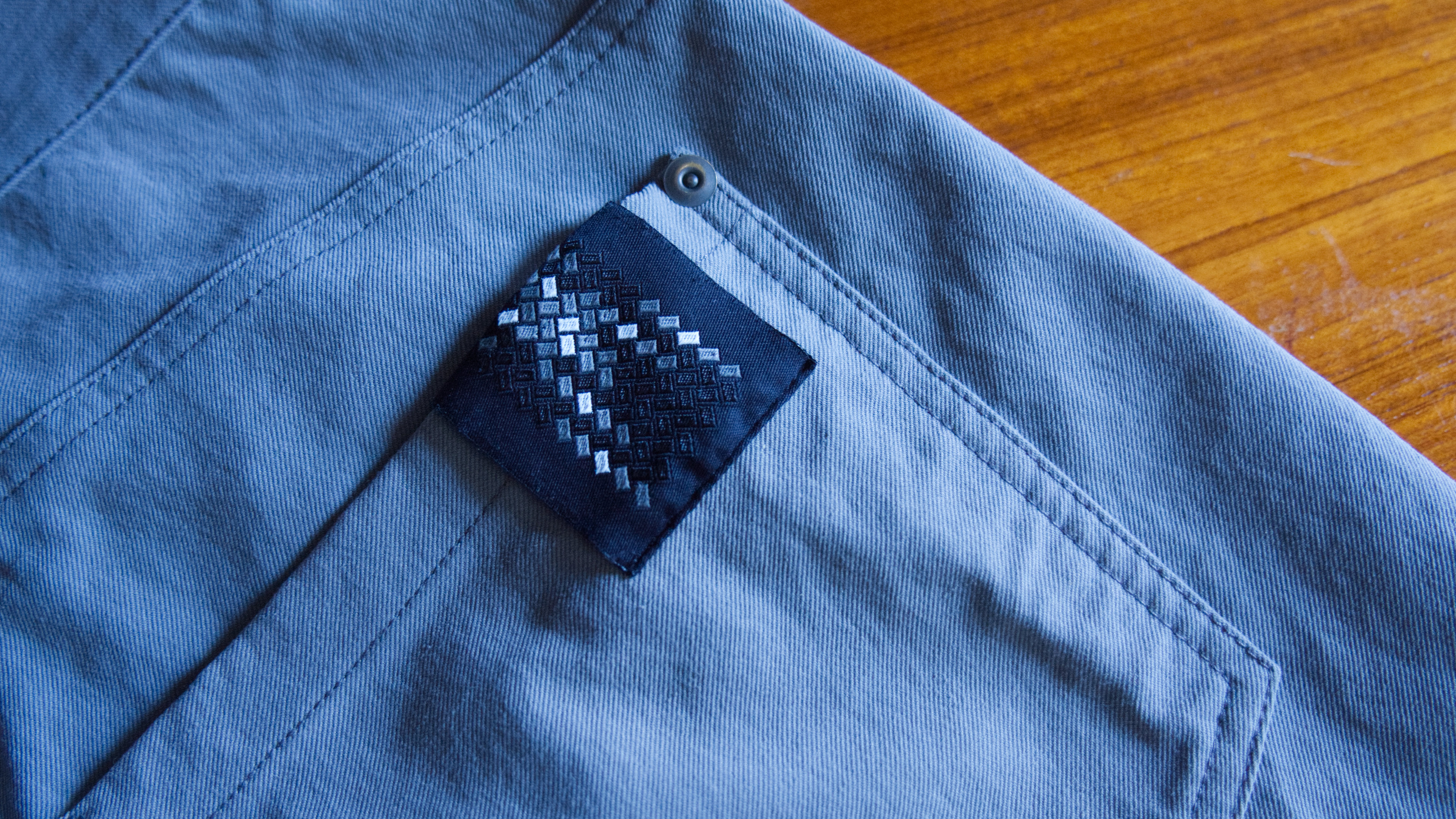 A stitched on logo patch on a pair of Bombdeuxs from Outlier.