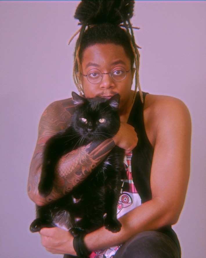 Isaiah Colbert and their cat, Majima. 