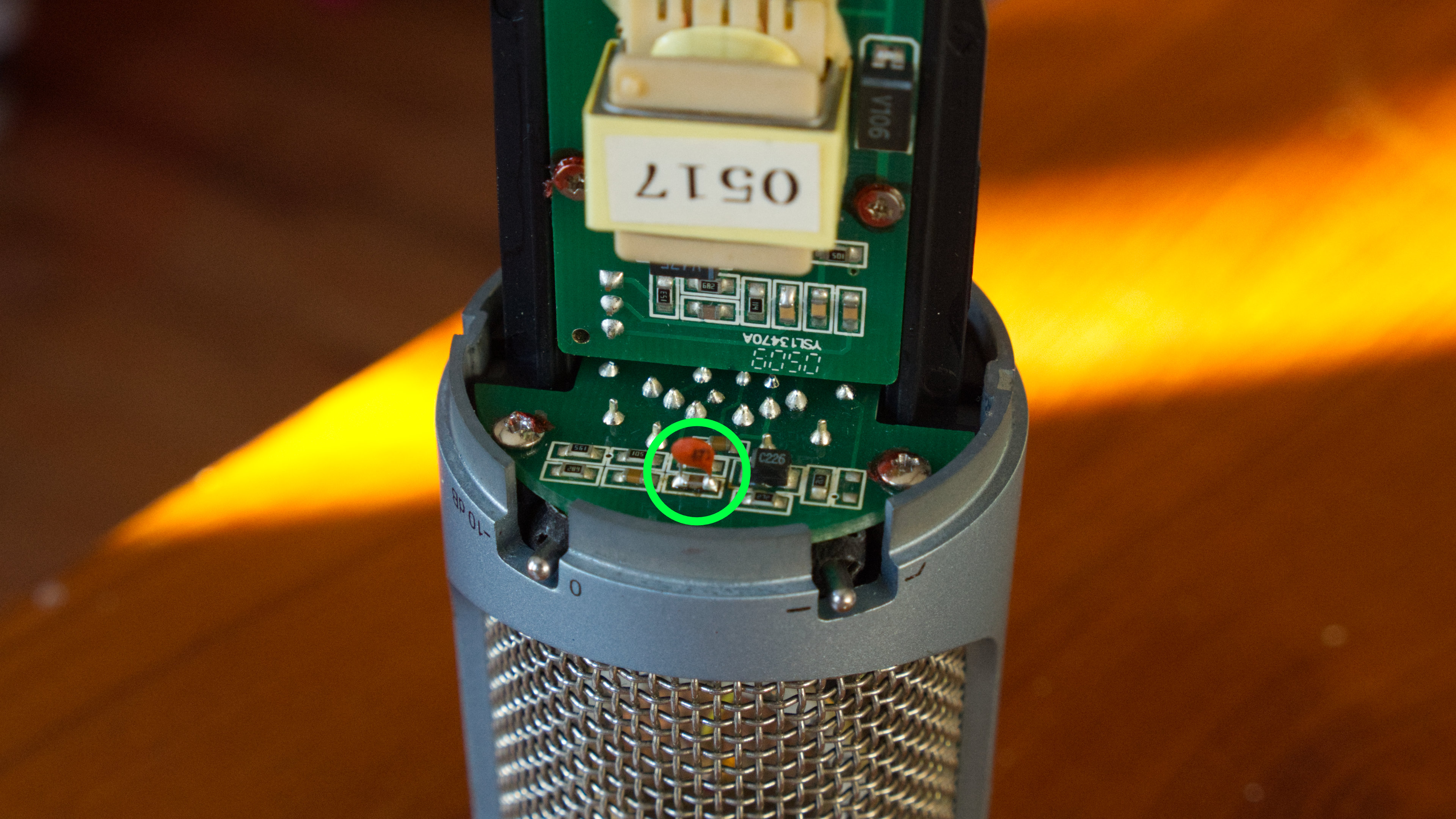 A modified AKG Perception 200, with a green circle where I soldered in a capacitor.