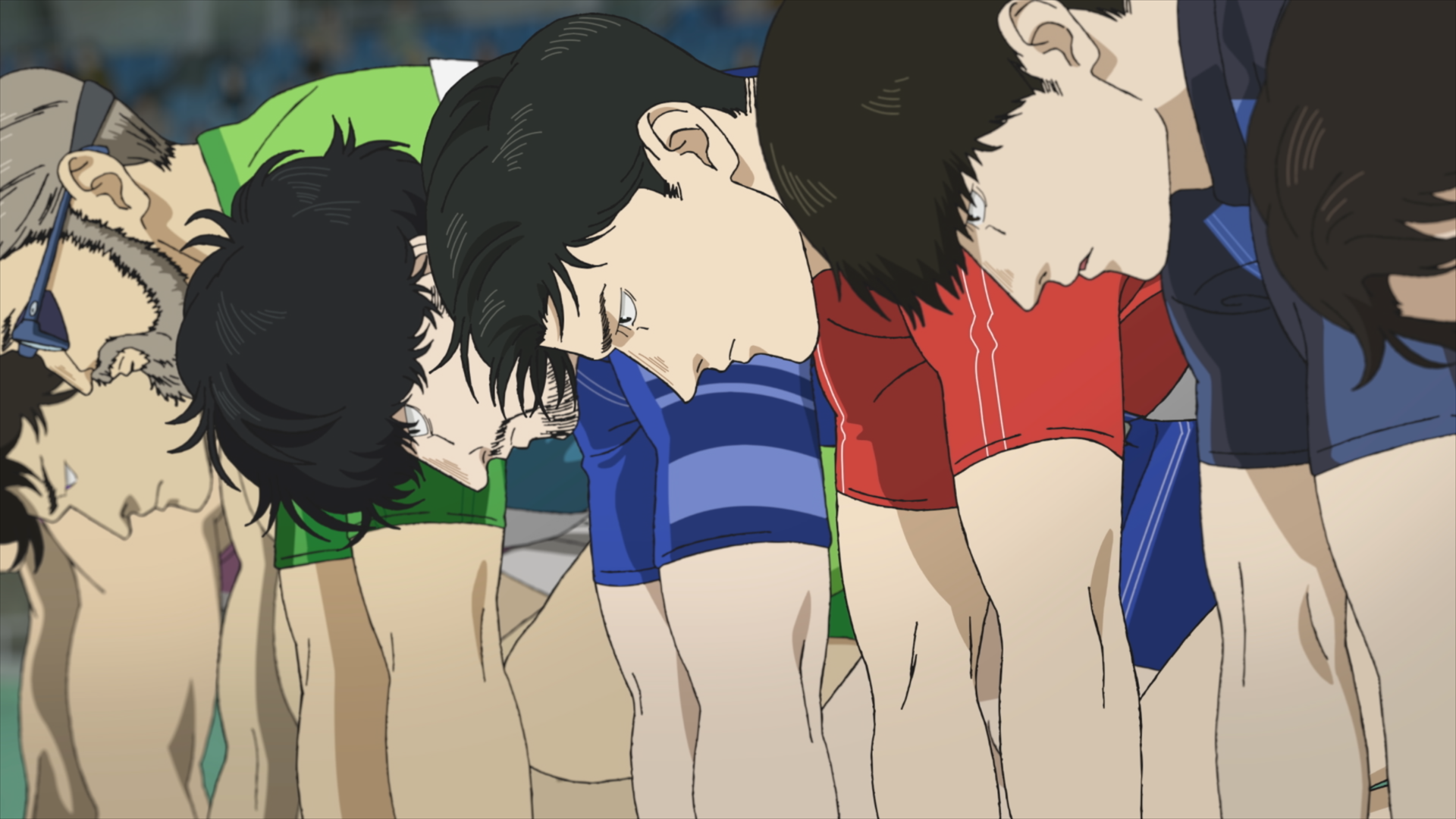100 Meters still of Togashi and Komiya in the starting blocks of their race.