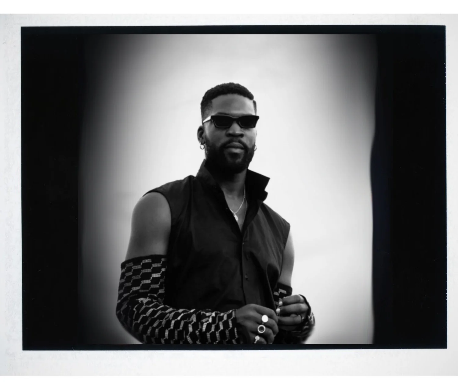 Black and white photo of Alexander-Julian Gibbson in Vogue Germany for street-style at Lagos Fashion week 