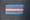 A trans flag, made of blue, pink, and white stripes, in chalk on black pavement